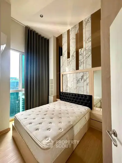 Luxurious bedroom with modern design and stunning city view, featuring a plush bed and elegant decor.