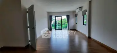 Spacious empty living room with large windows and garden view, perfect for customization.