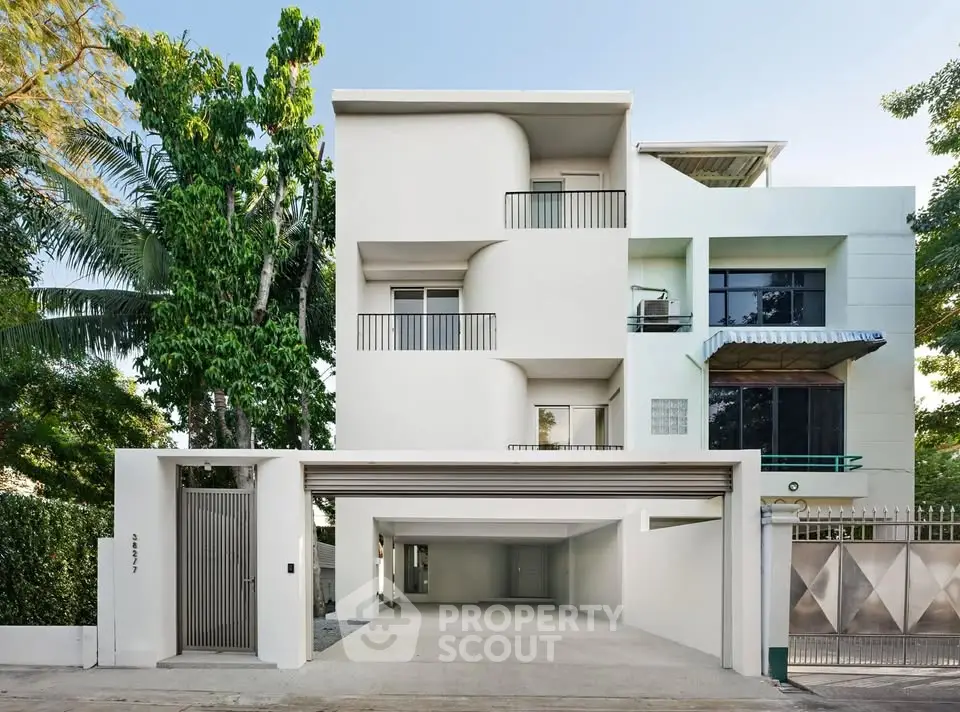 Modern minimalist building exterior with sleek design and spacious garage
