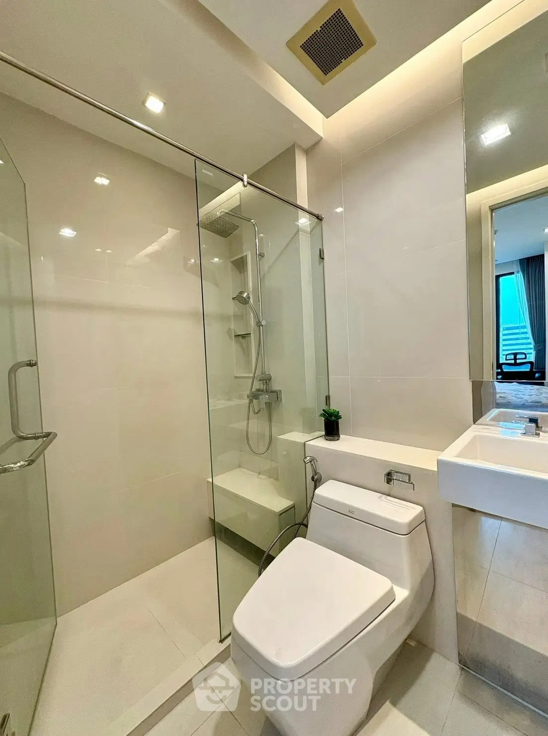 Modern bathroom with glass shower and sleek fixtures in a contemporary apartment.