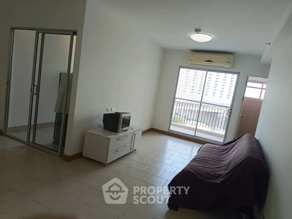 Spacious living room with balcony view in modern apartment