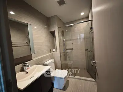 Modern bathroom with glass shower and sleek fixtures