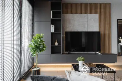 Chic modern living room with sleek design, featuring a large flat-screen TV, elegant furniture, and tasteful decor, perfect for urban living.