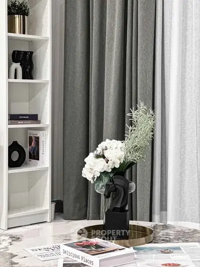 Elegant living room corner with stylish decor and modern bookshelf