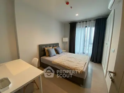 Modern bedroom with stylish decor and natural light in a contemporary apartment.