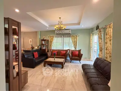 Spacious living room with elegant decor and ample natural light, featuring comfortable seating and stylish furnishings.