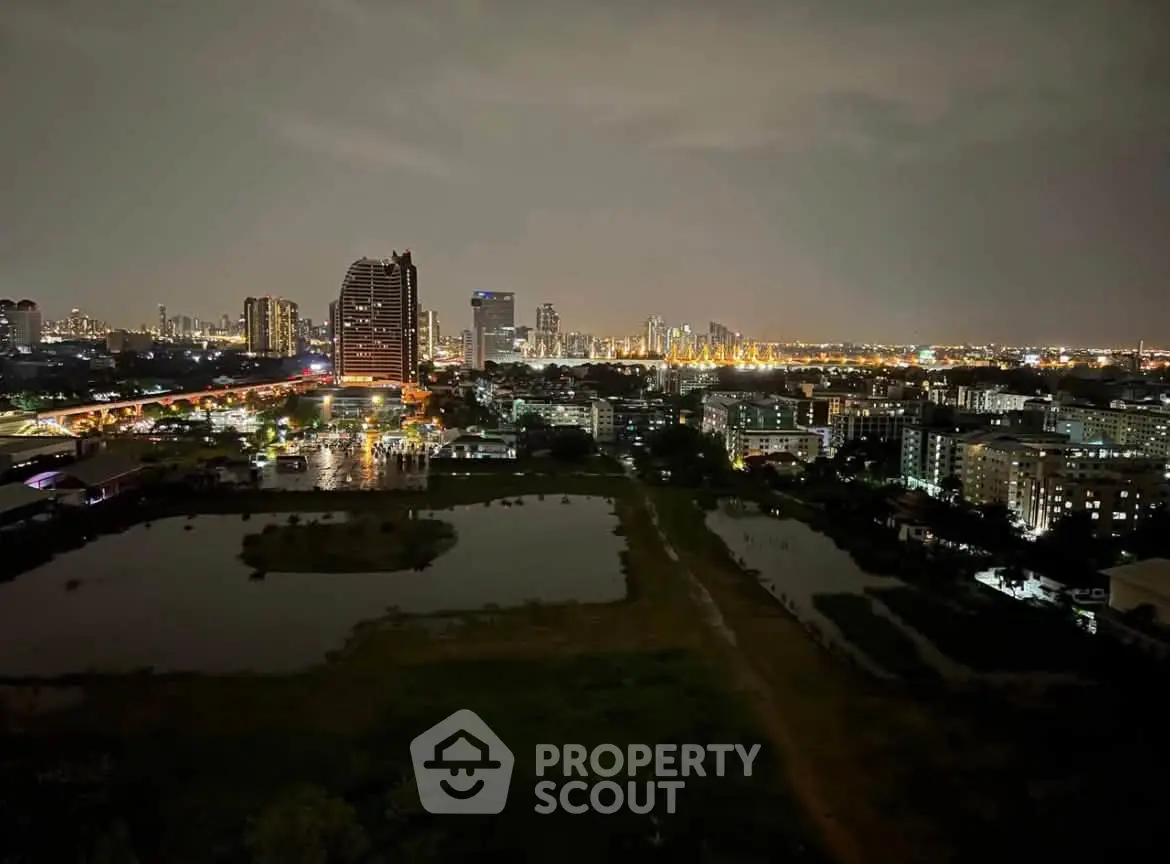 Stunning cityscape view from high-rise apartment at night with illuminated skyline.