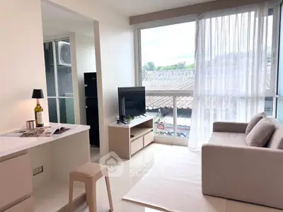 Bright modern living room with large window and cozy sofa, perfect for relaxation.