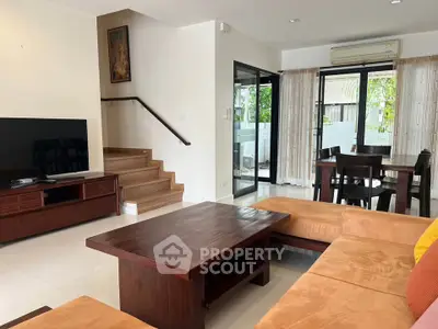 Spacious living room with modern furniture and dining area in a stylish home.