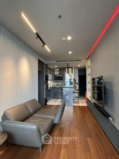 Modern living room with sleek design, open kitchen layout, and stylish lighting.