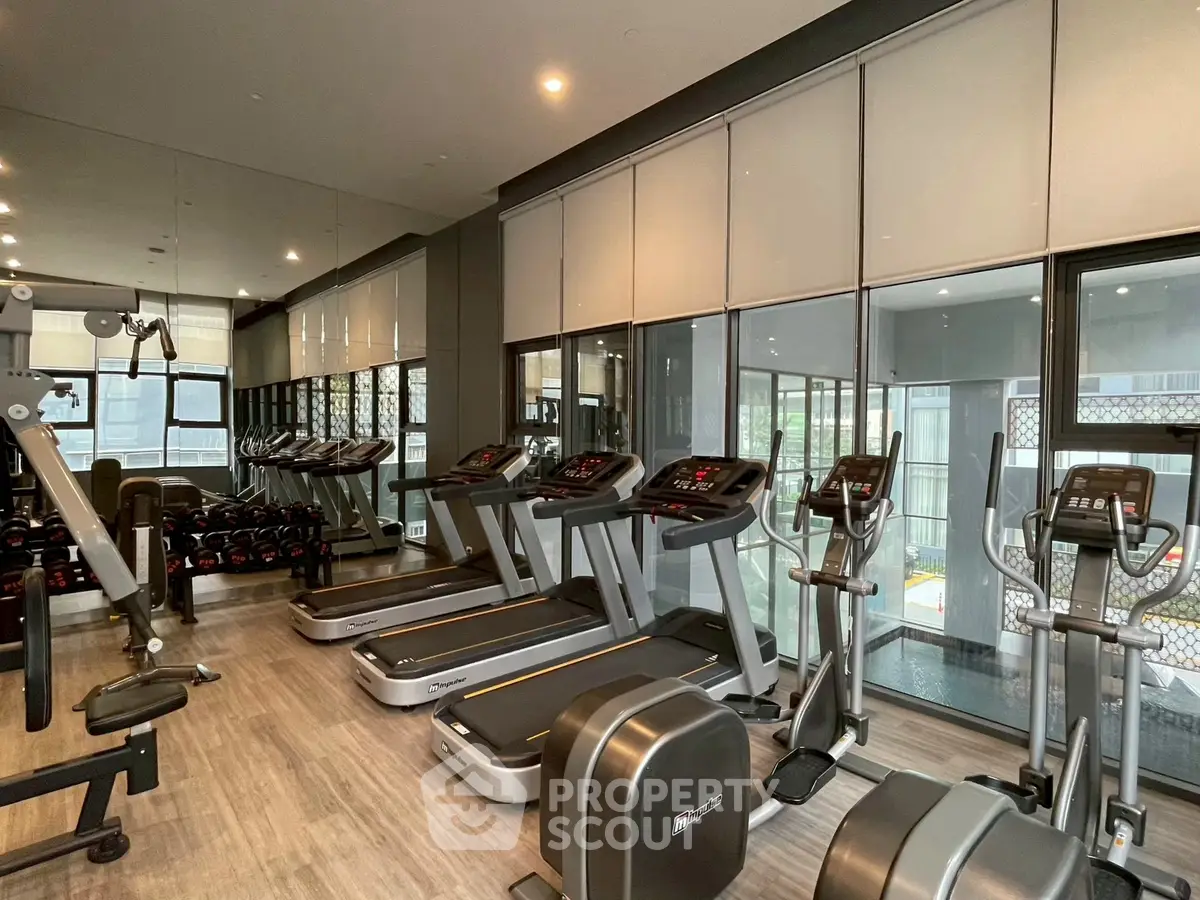 Modern gym with state-of-the-art equipment in luxury residential building.