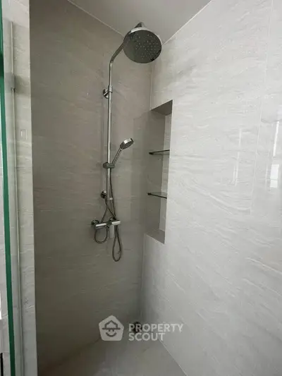 Modern bathroom shower with sleek design and glass shelves