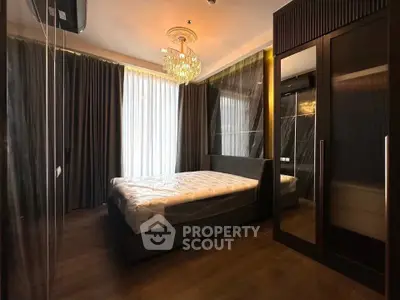 Luxurious bedroom with elegant chandelier and floor-to-ceiling curtains