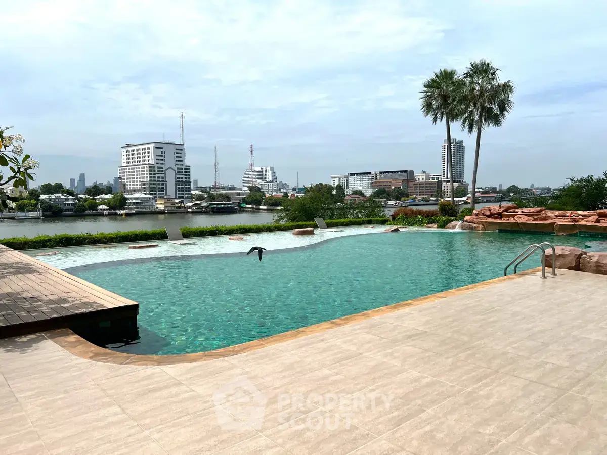Luxurious riverside pool with stunning cityscape view, perfect for relaxation and leisure.