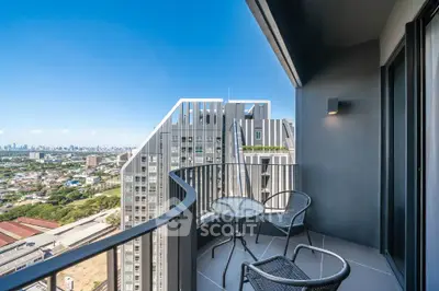 Stunning balcony view from modern high-rise apartment with city skyline backdrop.