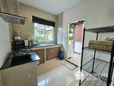 Modern kitchen with gas stove and outdoor access in a stylish home