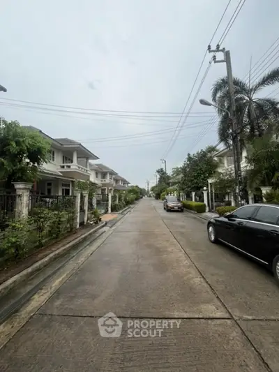 Charming suburban street with modern houses and lush greenery, ideal for family living.