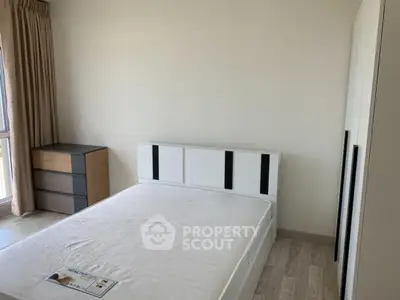 Spacious bedroom with modern furniture and natural light