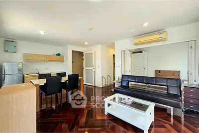 Spacious living room with modern furniture and wooden flooring