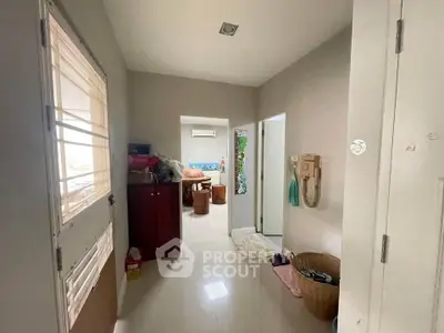 Spacious hallway leading to a cozy living area with modern decor.