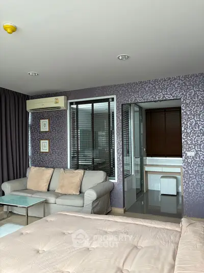 Modern bedroom with elegant decor and en-suite bathroom in a stylish apartment.