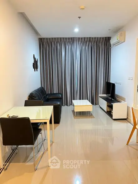 Modern living room with sleek furniture and large window curtains