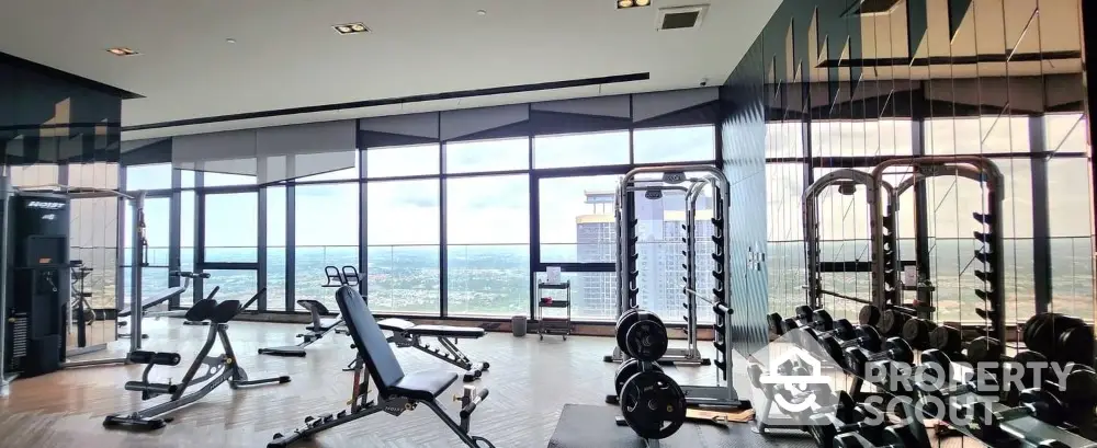 Luxury high-rise gym with panoramic city views and modern fitness equipment.