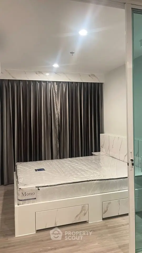 Modern bedroom with sleek design and floor-to-ceiling curtains in a stylish apartment.