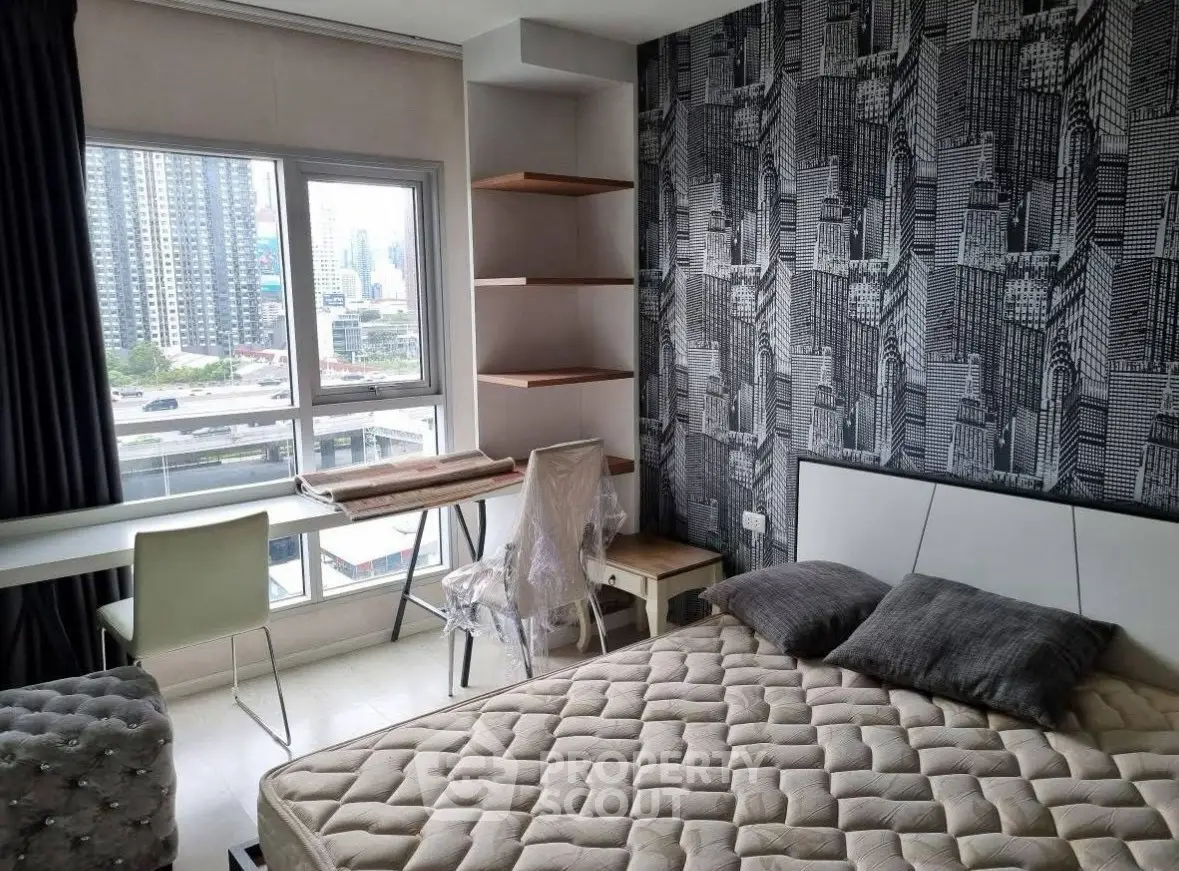 Modern bedroom with city view, stylish wallpaper, and cozy furnishings.