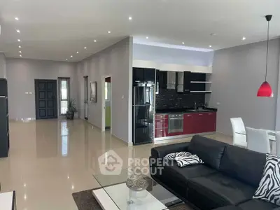 Spacious modern living room with open kitchen and stylish decor