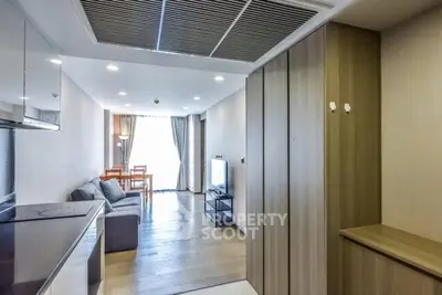 Modern living room with sleek design and natural light, featuring a cozy sofa and dining area.