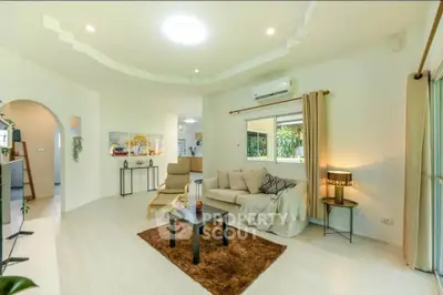 Spacious living room with modern decor and large window view
