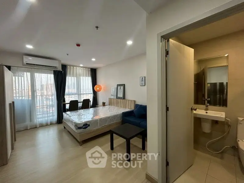 Modern studio apartment with open layout, featuring a cozy living area and bedroom, perfect for urban living.