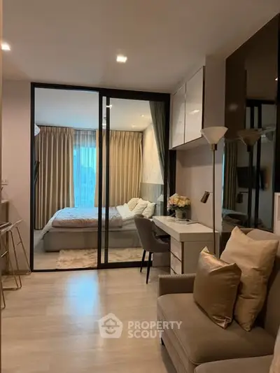 Modern apartment interior with cozy bedroom and stylish living area, featuring elegant decor and natural lighting.