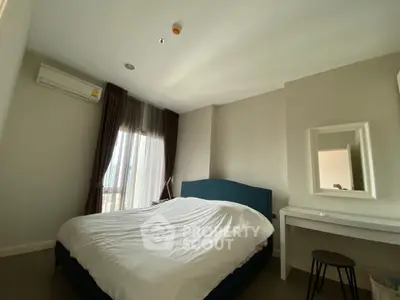 Cozy bedroom with modern decor and natural light from large window