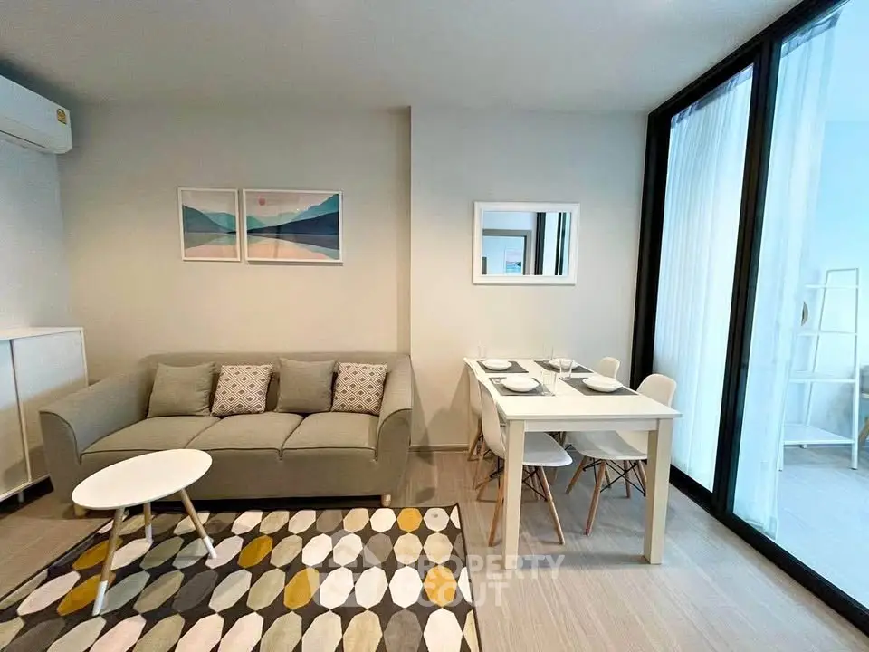 Modern living room with stylish decor and dining area in a bright apartment.