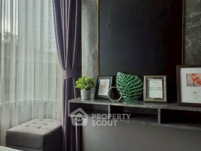 Stylish modern living room with elegant decor and large window view.