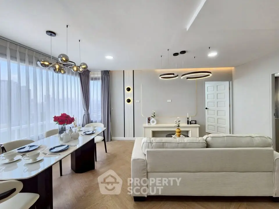 Modern living room with elegant dining area and stylish lighting fixtures