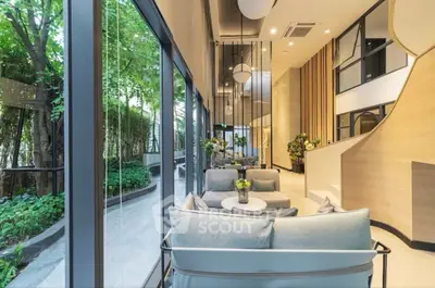 Luxurious modern living room with floor-to-ceiling windows and lush garden view