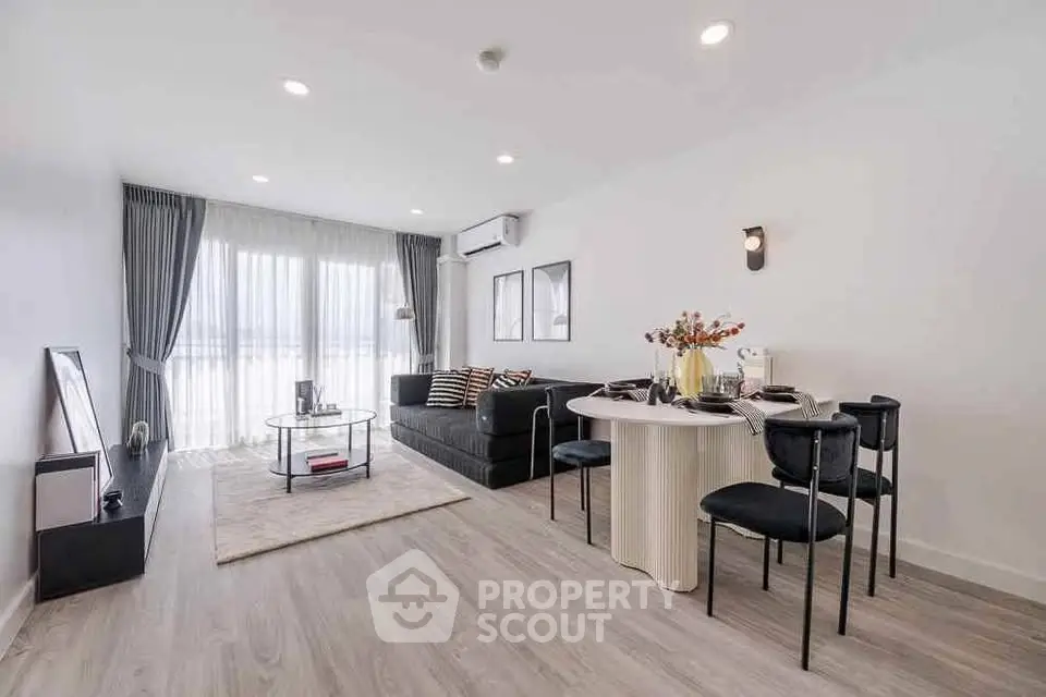 Modern living room with stylish decor and natural light in a contemporary apartment.