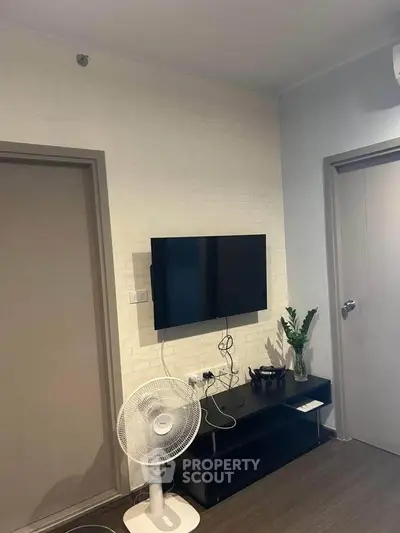 Modern living room with wall-mounted TV and minimalist decor