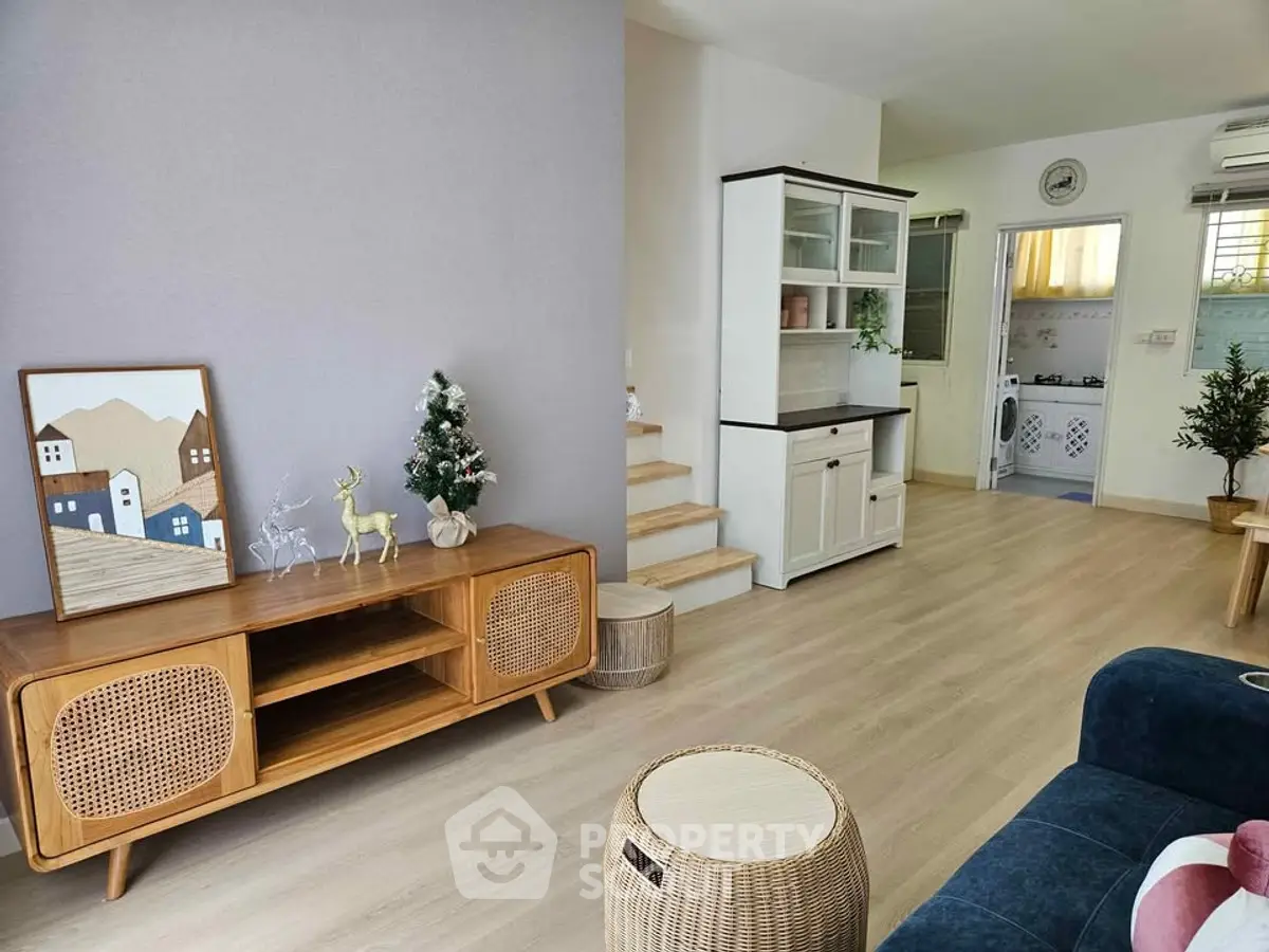 Charming living room with modern decor and open kitchen layout