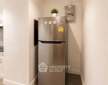 Modern kitchen with sleek stainless steel refrigerator and stylish decor.