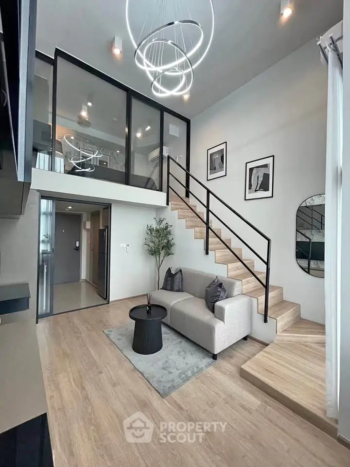 Modern duplex living room with stylish decor and elegant staircase