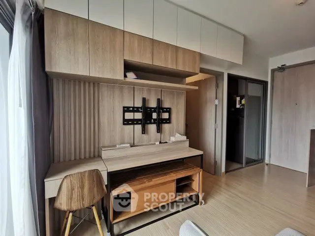 Modern apartment interior with stylish wooden furniture and ample storage space.