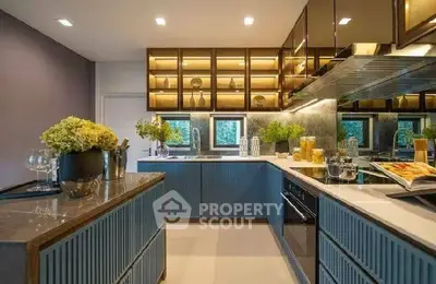 Modern kitchen with sleek cabinetry and stylish lighting, featuring a gas stove and open layout for culinary enthusiasts.