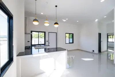 Modern open-plan kitchen with sleek design and ample natural light