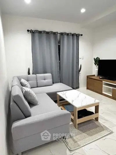 Modern living room with gray sectional sofa and marble coffee table