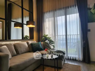Stylish living room with cozy sofa, elegant lighting, and large window offering stunning views.
