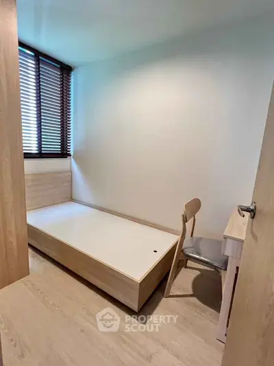 Cozy minimalist bedroom with wooden furniture and natural light